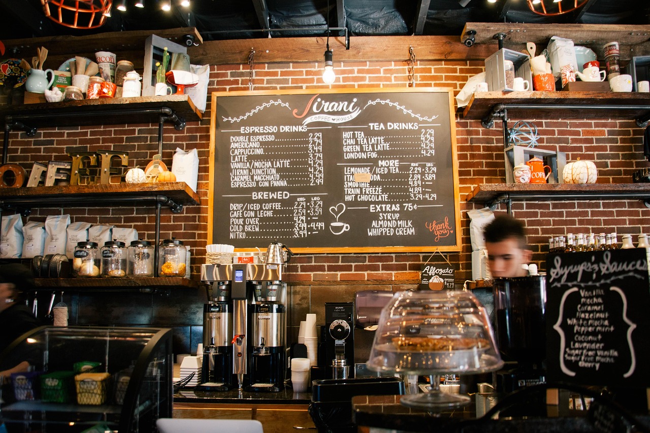 The service counter at Drip Theory with bags on the shelf behind