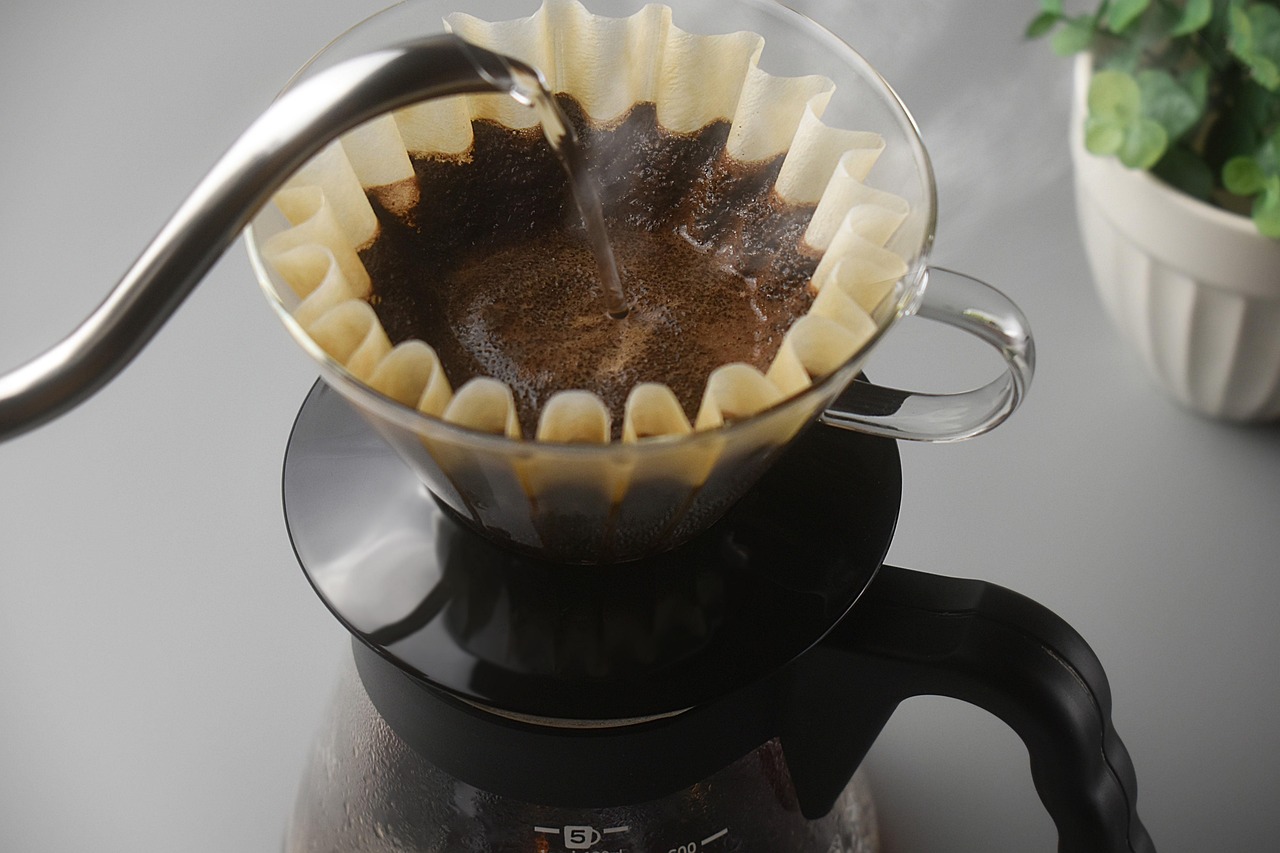 A slow pour-over brewing onto a scale at the counter